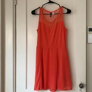 Coral pink mini dress with mesh neckline.